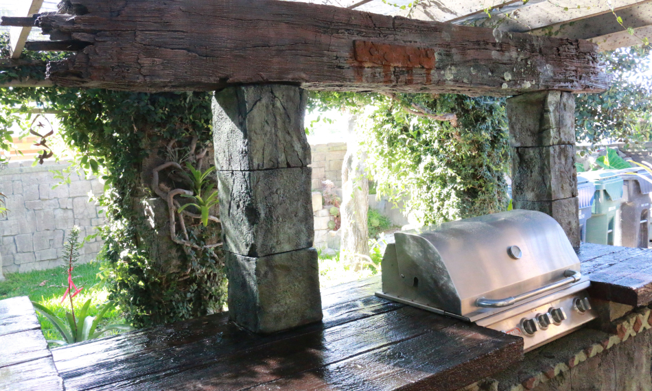 Outdoor kitchen pergola with sculpted stone columns