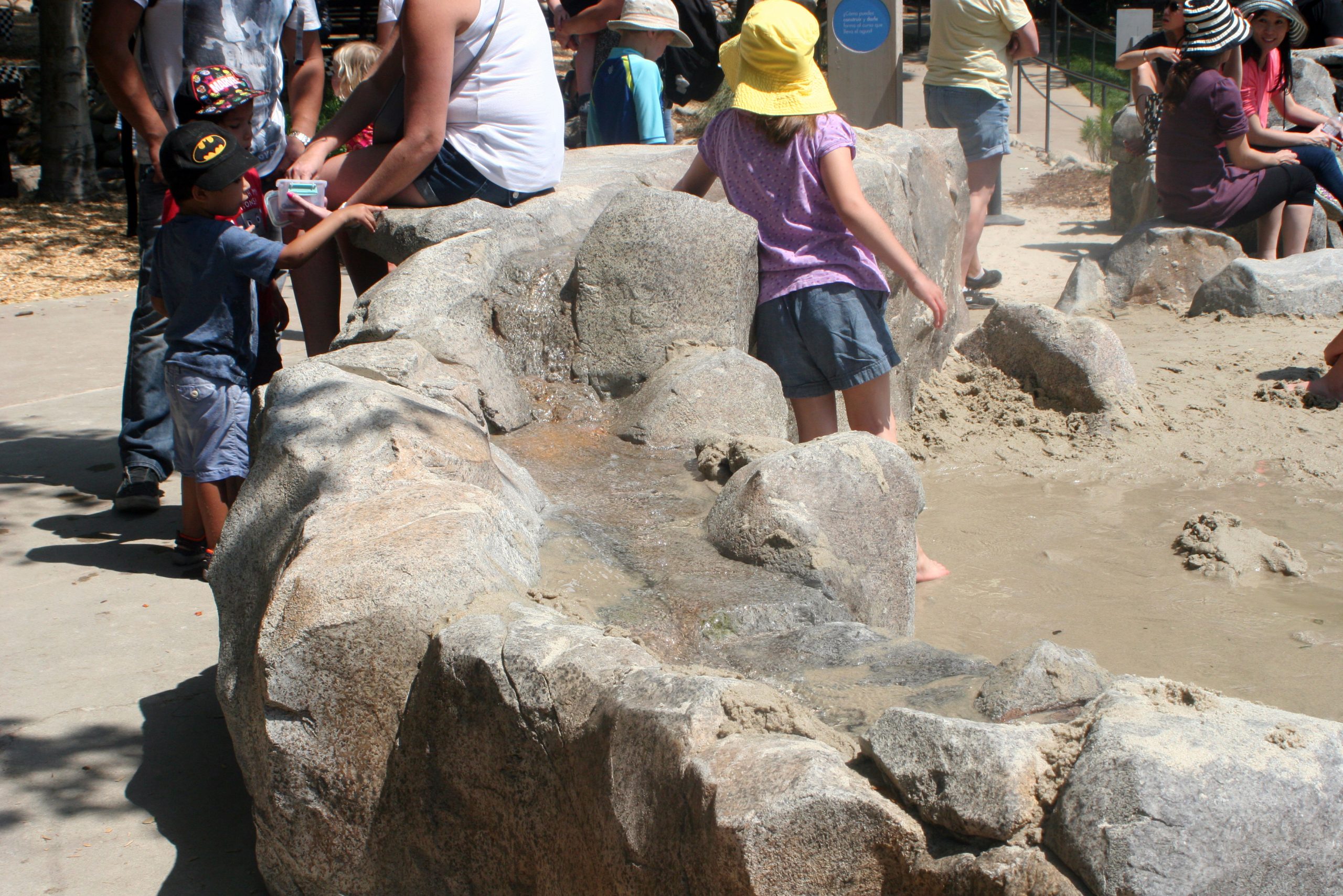 Children playing on smooth concrete boulder formations