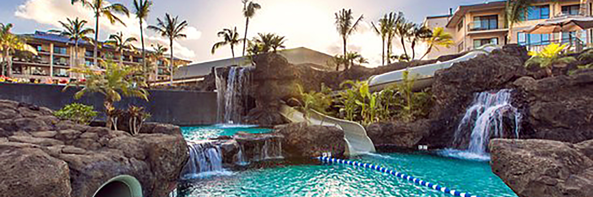 Resort pool complex with concrete rock waterfalls and lazy river